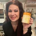 Customer smiling and holding a jar of Advanced Vaginal Support