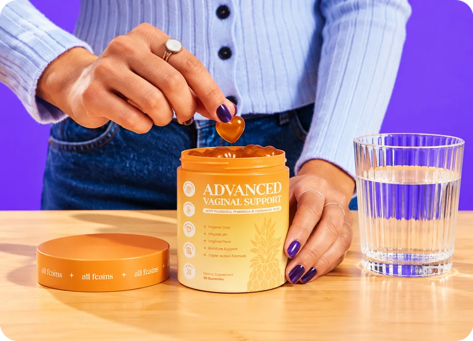 Hands taking a gummy from an open jar of Advanced Vaginal Support
