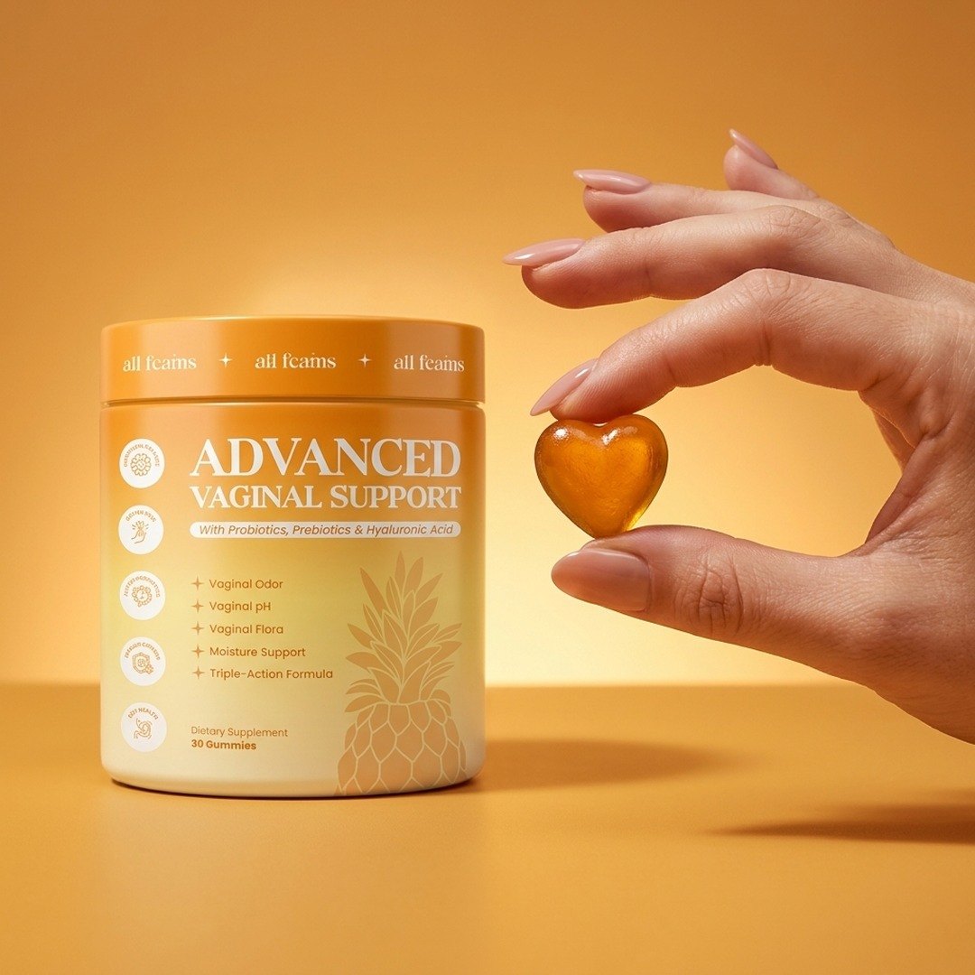 A hand holding one gummy next to the jar