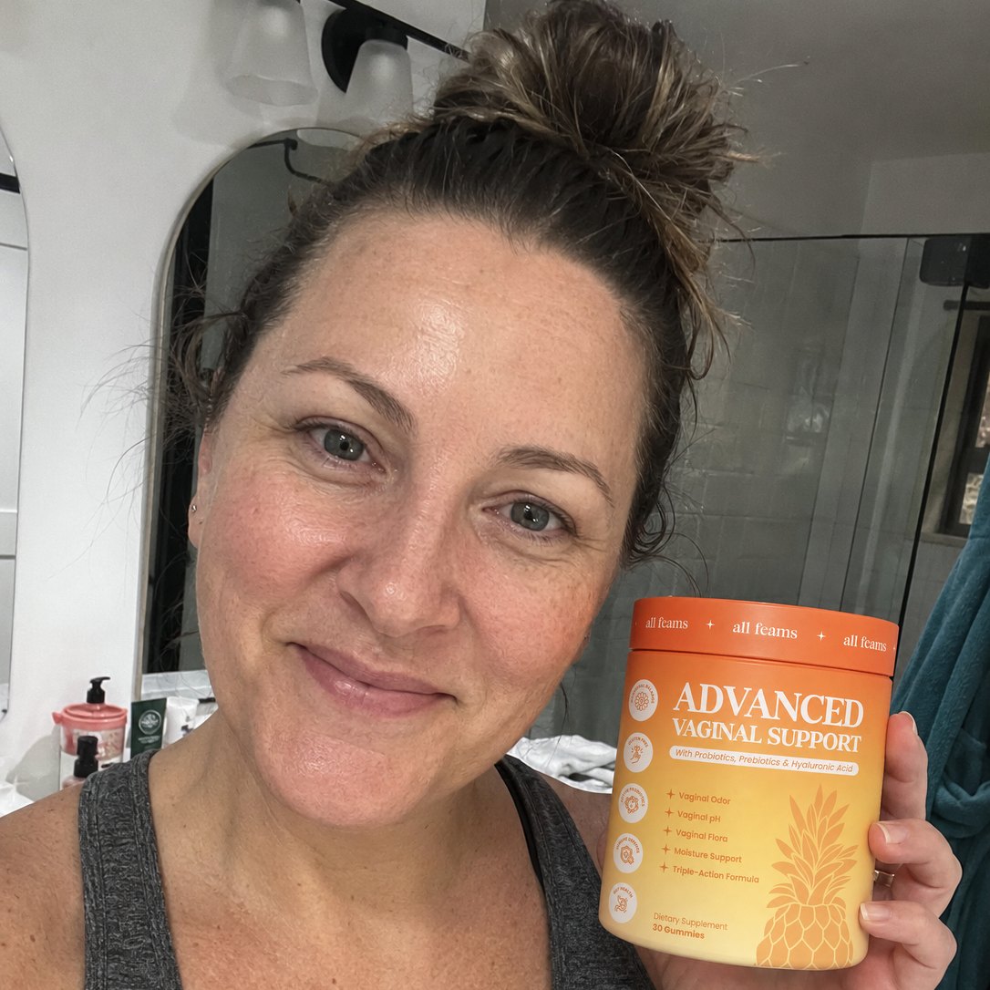 A woman in her bathroom holding the jar