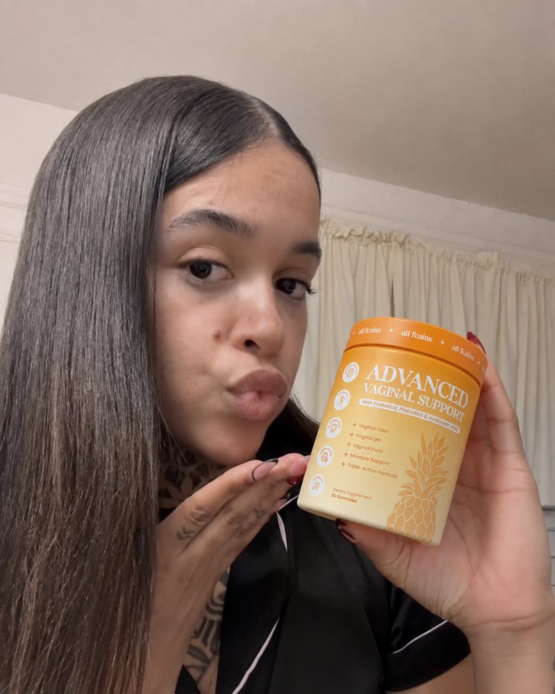 A woman at home holding the jar